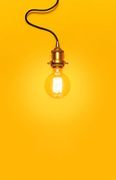 an old fashioned light bulb on a yellow background