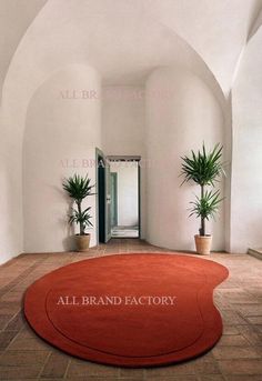 the entrance to an all brand factory with potted plants on the floor in front of it