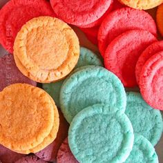 colorful cookies are arranged in rows on a plate