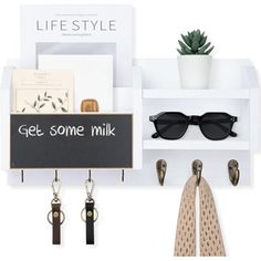 a white shelf with sunglasses, keychain and card holder