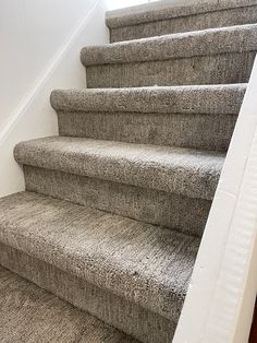 a carpeted staircase leading up to the second floor