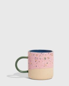 a pink and blue mug with speckles on it