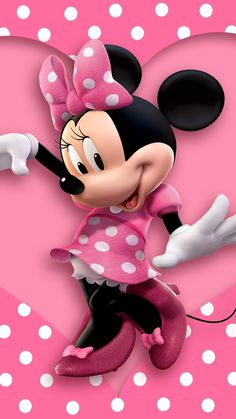 a minnie mouse with polka dots on it's head and arms, standing in front of a pink heart