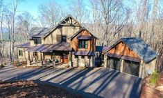 this is an aerial view of a house in the woods with lots of trees around it