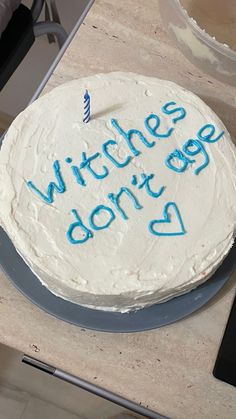 a white cake with blue writing on it