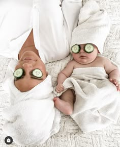 two babies with cucumbers on their eyes laying next to each other in towels