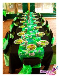 a long table covered in green and black cloths