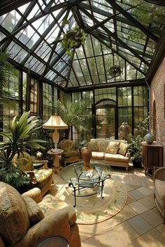 a living room filled with lots of furniture and plants in it's center area