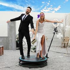 a man and woman dressed in formal wear standing on a trampoline