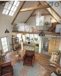 an aerial view of a living room and kitchen area in a loft with exposed beams