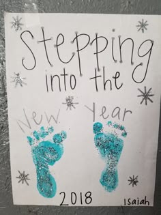 a hand and foot imprint on a sign that says stepping into the new year 2013