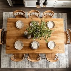 an overhead view of a dining room table with place settings and plates on the top