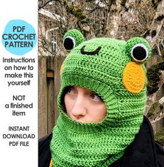 a woman wearing a green frog hat and scarf with eyes on it's face