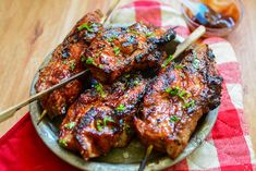 meat skewers on a plate with dipping sauce