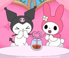 two cartoon characters sitting at a table with a heart shaped object in front of them