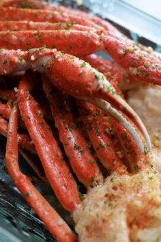 cooked lobsters with garlic and seasoning in a glass dish