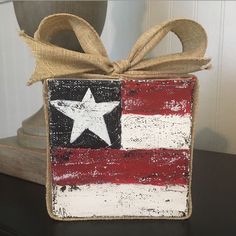 an american flag painted on the side of a box with a ribbon tied around it