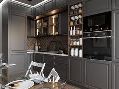 a modern kitchen with gray cabinets and silver accessories on the dining room table set for four