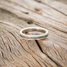 a silver ring sitting on top of a wooden table