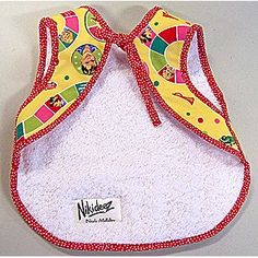 a bib with a red and yellow design on the front that says nick n nibbles