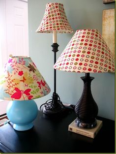 two lamps are sitting on a table next to each other