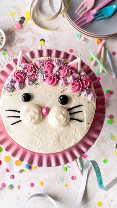 a cake decorated to look like a cat with flowers on it's head and eyes