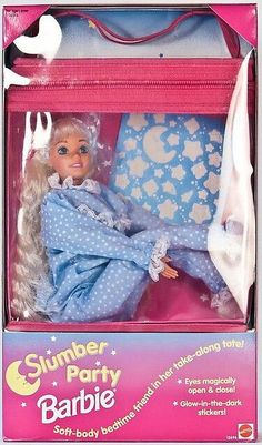 a doll in a pink suitcase with white polka dots on it's clothes and hair