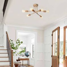 a living room with white walls and wood floors