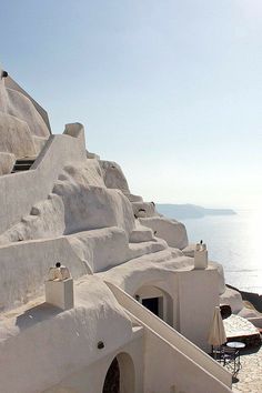 an outdoor seating area on the side of a cliff