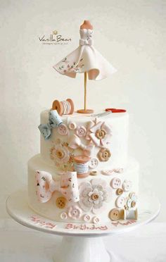 a wedding cake with buttons and an umbrella on top