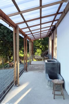 the inside of a building that has a bench in front of it and some trees on the other side