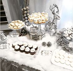 a table topped with lots of desserts and cupcakes on top of it