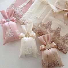 several different types of laces and bows laid out on a white tablecloth,