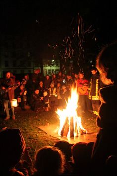 people sitting around a campfire at night