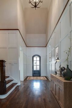 a hallway with wooden floors and white walls