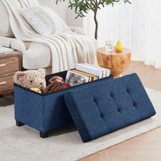 a blue ottoman sitting on top of a wooden floor