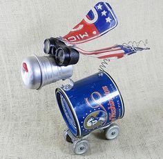 two tin cans are on wheels and one is upside down