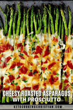 asparagus with prosciutto and cheese on a baking sheet for an appetizer