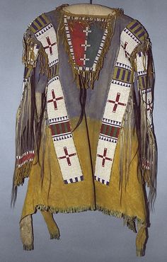 an old native style jacket hanging on a wall