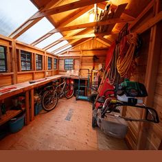 the inside of a wooden building with lots of tools