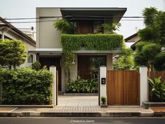 a house with lots of greenery on the front