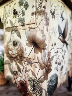 a painted dresser with flowers and birds on it