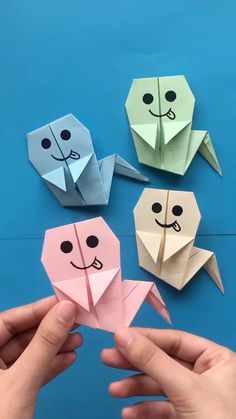 three origami animals are shown with one being folded up in the shape of a cat