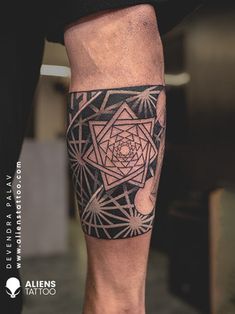 a man's leg with a tattoo on it that has an image of a flower in the center