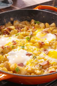 an orange pan filled with eggs and potatoes