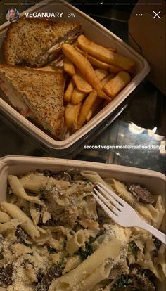 two plastic containers filled with food on top of a table next to a sandwich and french fries