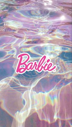 the logo for barbie is reflected in clear, blue water with ripples on it