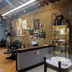 a barber shop with brick walls and wooden floors