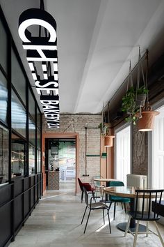 the interior of a restaurant with tables and chairs