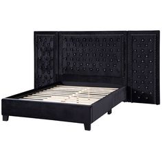 a black bed with studded headboard and foot board